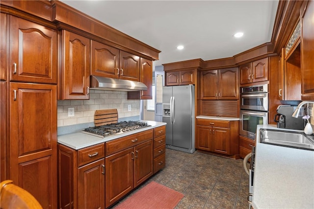 104 Textor Dr N, Versailles, PA 15137 - kitchen with stainless steel appliances, under cabinet range hood, light countertops, tasteful backsplash, and recessed lighting