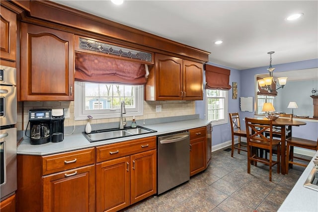 104 Textor Dr N, Versailles, PA 15137 - kitchen with appliances with stainless steel finishes, decorative backsplash, light countertops, pendant lighting, and a chandelier