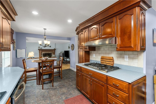 104 Textor Dr N, Versailles, PA 15137 - kitchen featuring under cabinet range hood, stainless steel gas cooktop, tasteful backsplash, light countertops, and recessed lighting