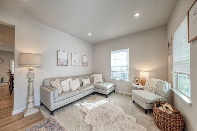 living area with recessed lighting, light wood finished floors, and baseboards