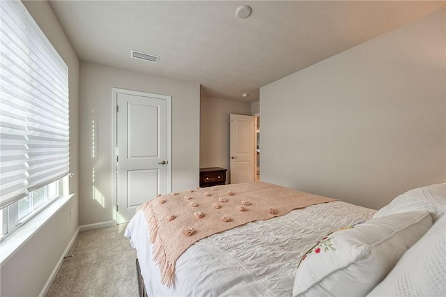 bedroom featuring light carpet, baseboards, and visible vents