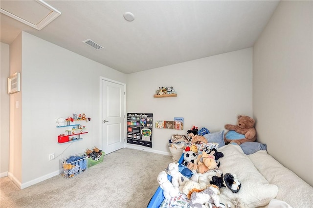 carpeted bedroom featuring attic access, visible vents, and baseboards