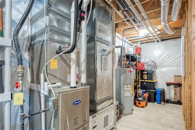 utility room featuring heating unit and electric water heater