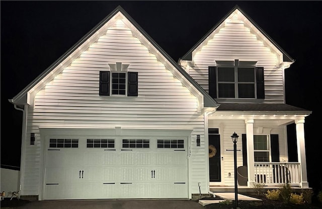 view of front facade with covered porch, concrete driveway, and an attached garage