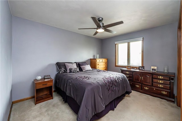 bedroom with baseboards, light colored carpet, and ceiling fan