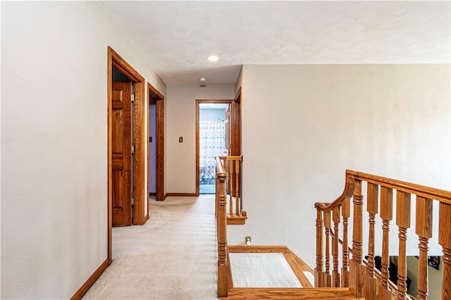 hall featuring an upstairs landing, baseboards, recessed lighting, and light colored carpet