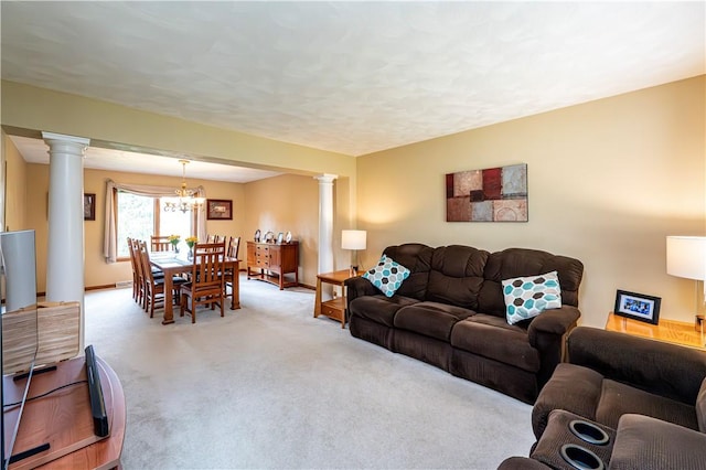 living area featuring baseboards, light carpet, a chandelier, and decorative columns