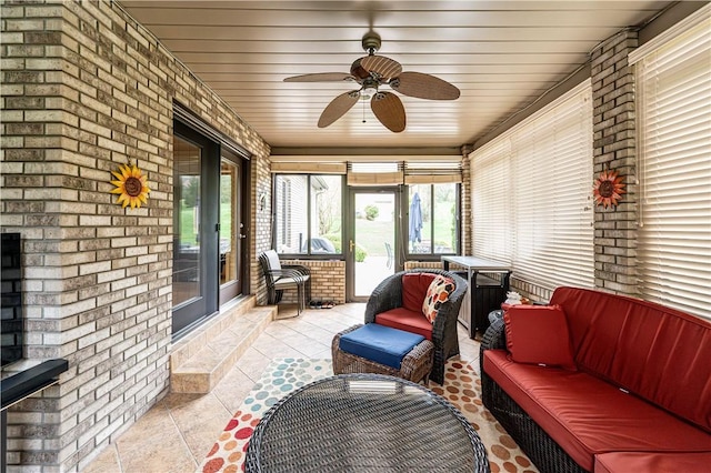 sunroom featuring plenty of natural light, a ceiling fan, and an outdoor hangout area