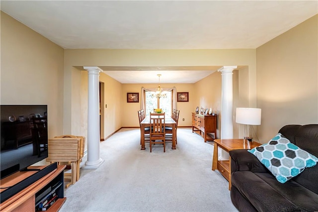 living room featuring a chandelier, baseboards, ornate columns, and light carpet