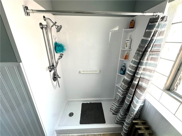 bathroom featuring a shower stall and a healthy amount of sunlight