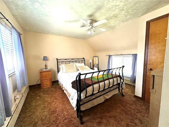 bedroom featuring dark colored carpet, a textured ceiling, a ceiling fan, and multiple windows