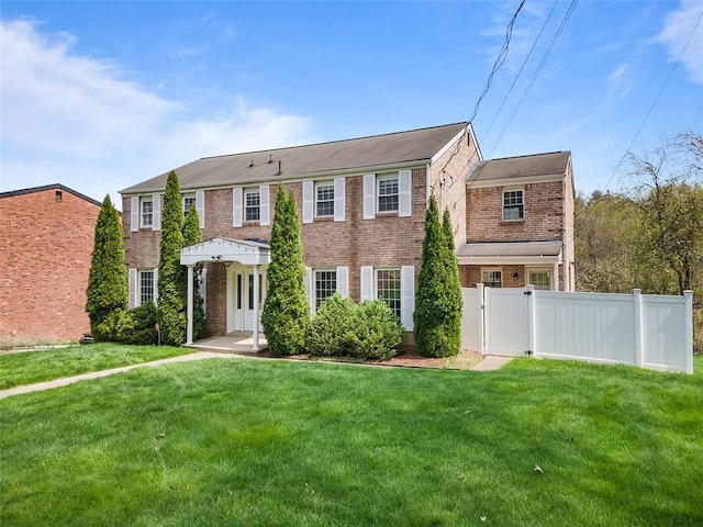 2007 Garrick Dr, Churchill Boro, PA 15235 - colonial inspired home with brick siding, a front yard, and fence