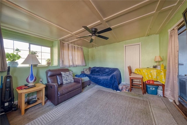 carpeted bedroom with coffered ceiling, ceiling fan, and beamed ceiling