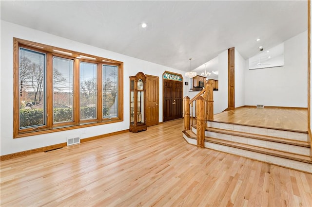 86 Lambeth Dr, Upper St Clair, PA 15241 - unfurnished living room featuring lofted ceiling, a notable chandelier, visible vents, and light wood-style floors