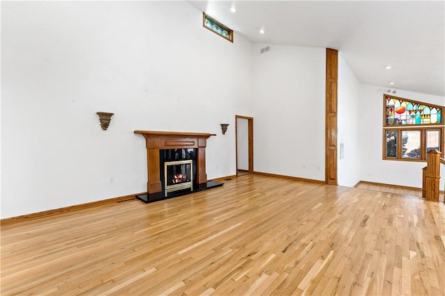 86 Lambeth Dr, Upper St Clair, PA 15241 - unfurnished living room with recessed lighting, visible vents, light wood-style floors, a glass covered fireplace, and high vaulted ceiling