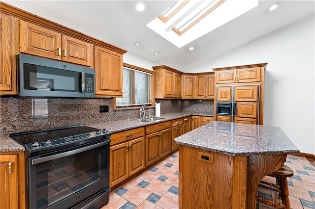 86 Lambeth Dr, Upper St Clair, PA 15241 - kitchen with vaulted ceiling with skylight, a sink, brown cabinets, black electric range, and stainless steel microwave
