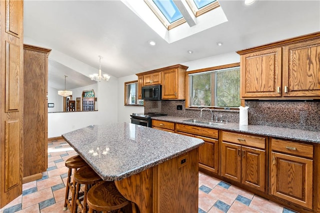86 Lambeth Dr, Upper St Clair, PA 15241 - kitchen with brown cabinets, stainless steel range with electric cooktop, a sink, lofted ceiling with skylight, and black microwave