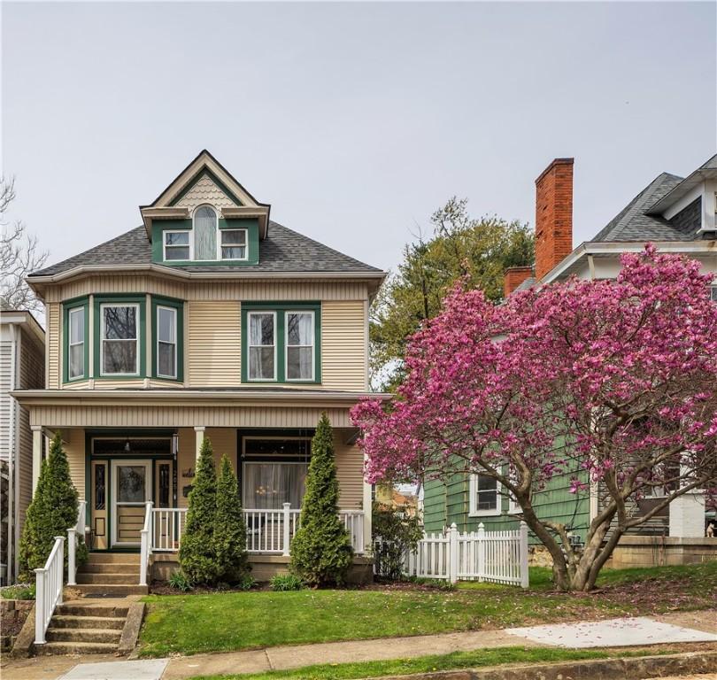 205 Harrison Ave, Avalon, PA 15202 - view of front of house featuring a porch, a front lawn, fence, and a shingled roof