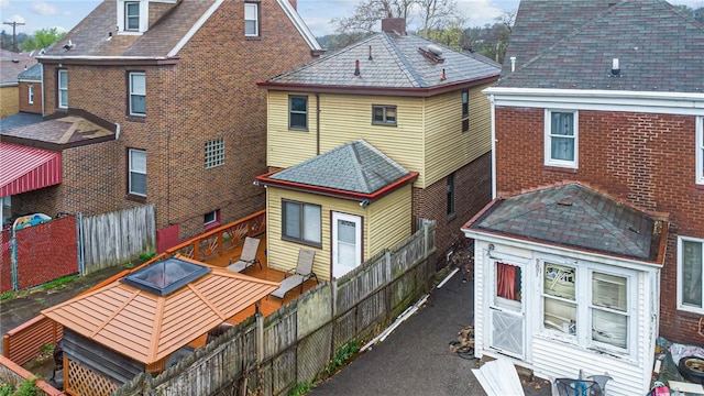 1323 Methyl St, Beechview, PA 15216 - rear view of property featuring a fenced backyard, a chimney, brick siding, and a deck