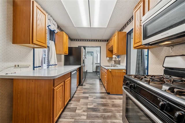 1323 Methyl St, Beechview, PA 15216 - kitchen featuring light countertops, light wood-style floors, appliances with stainless steel finishes, and a sink