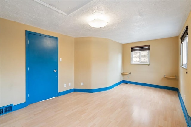 814 Greenfield Ave, Greenfield, PA 15217 - empty room with attic access, wood finished floors, a textured ceiling, and visible vents