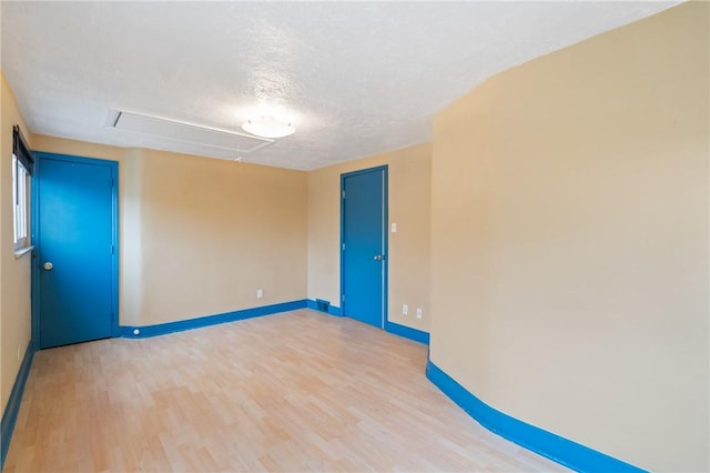 814 Greenfield Ave, Greenfield, PA 15217 - empty room featuring attic access, wood finished floors, a textured ceiling, and baseboards