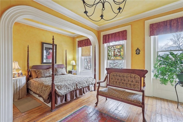 1319 Sheffield St, Manchester, PA 15233 - bedroom featuring arched walkways, hardwood / wood-style floors, ornamental molding, and a notable chandelier