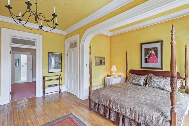 1319 Sheffield St, Manchester, PA 15233 - bedroom featuring arched walkways, crown molding, baseboards, hardwood / wood-style flooring, and a notable chandelier
