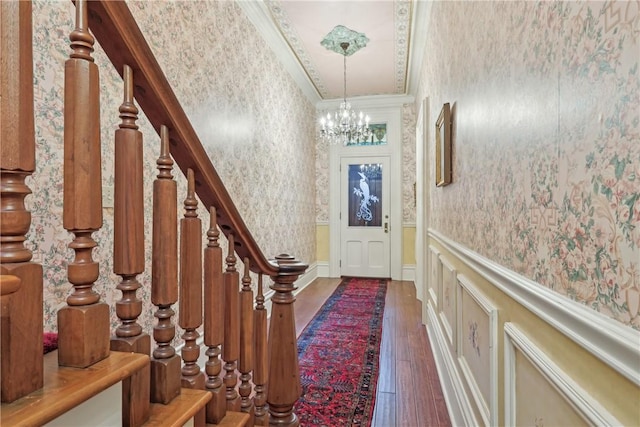 1319 Sheffield St, Manchester, PA 15233 - entrance foyer featuring wallpapered walls, hardwood / wood-style floors, a wainscoted wall, and an inviting chandelier