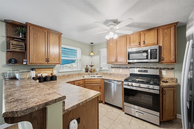 kitchen with open shelves, a ceiling fan, a sink, a peninsula, and appliances with stainless steel finishes
