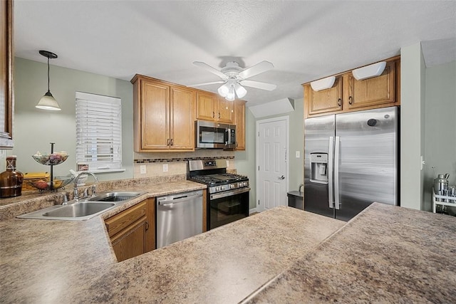 kitchen with stainless steel appliances, a sink, tasteful backsplash, pendant lighting, and ceiling fan