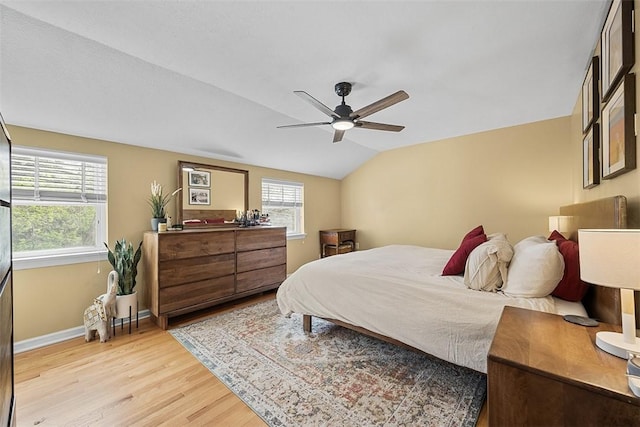 bedroom featuring ceiling fan, baseboards, lofted ceiling, and light wood finished floors