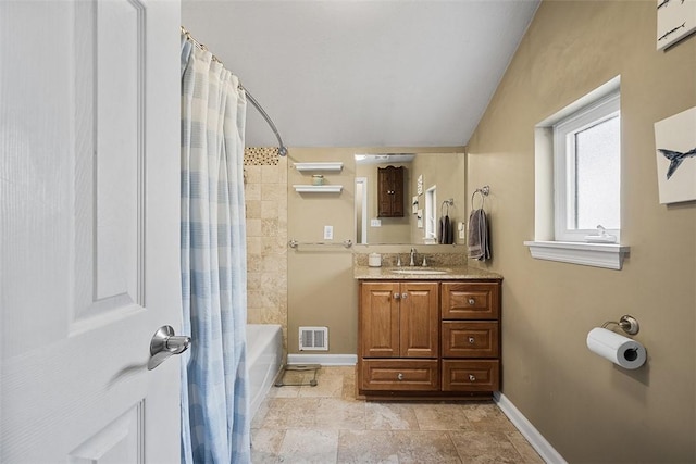 bathroom with visible vents, vanity, baseboards, and shower / bath combo with shower curtain