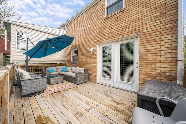 wooden terrace with an outdoor living space