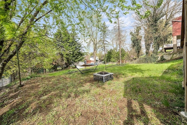 view of yard with a fire pit