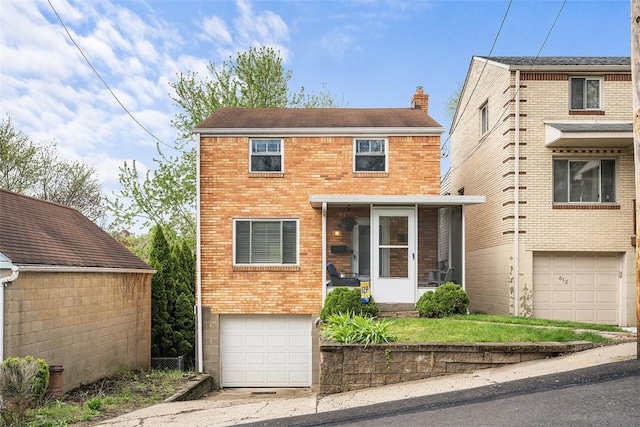 traditional-style house featuring an attached garage, driveway, a chimney, and brick siding