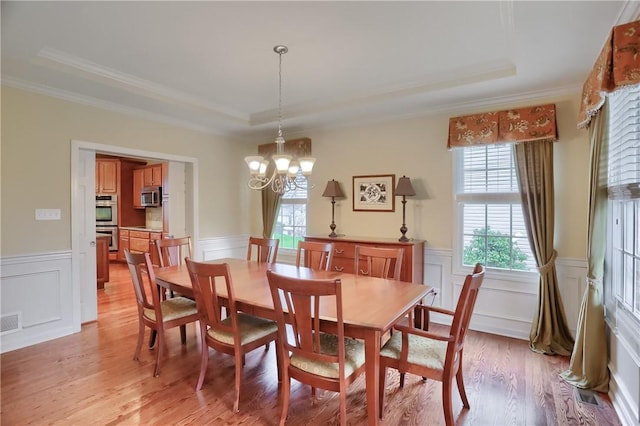 404 Plum Ct, Cranberry Twp, PA 16066 - dining space with a raised ceiling, crown molding, light wood finished floors, a chandelier, and wainscoting