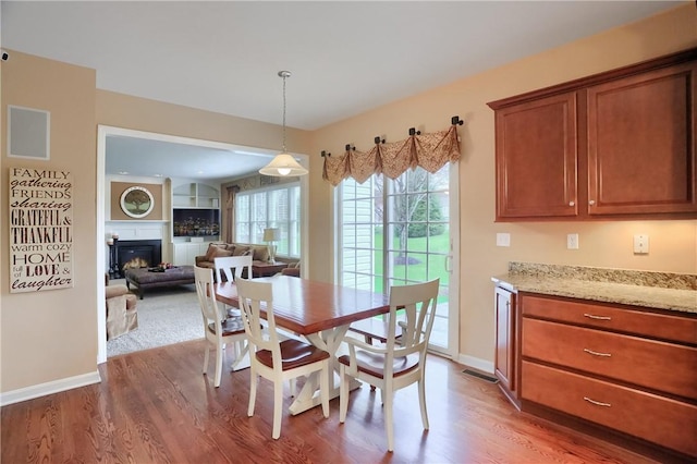 404 Plum Ct, Cranberry Twp, PA 16066 - dining room featuring wood finished floors, baseboards, and a glass covered fireplace