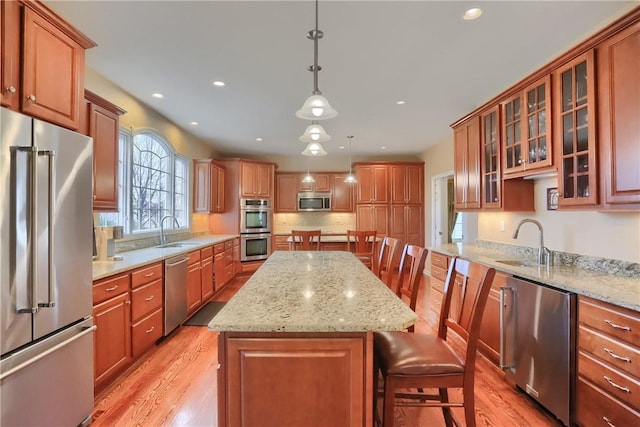 404 Plum Ct, Cranberry Twp, PA 16066 - kitchen featuring appliances with stainless steel finishes, a sink, a kitchen island, light wood-style floors, and recessed lighting