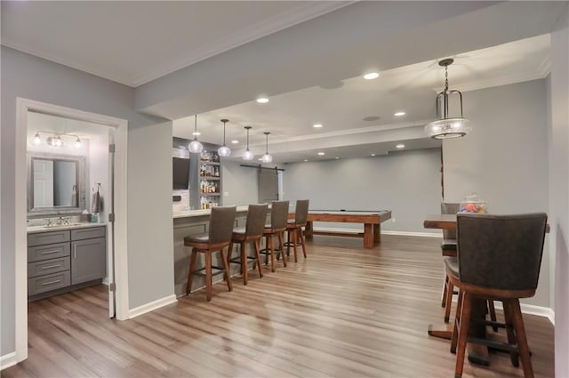 404 Plum Ct, Cranberry Twp, PA 16066 - dining space with crown molding, light wood-style flooring, bar area, baseboards, and recessed lighting