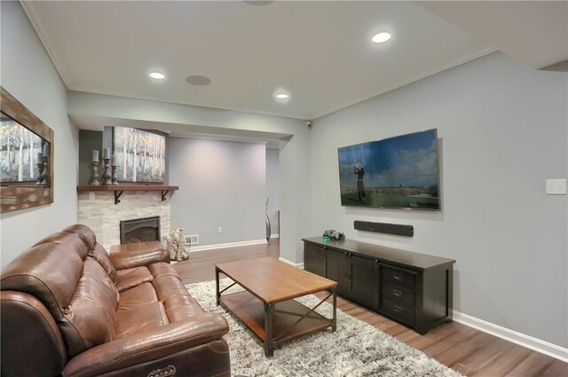 404 Plum Ct, Cranberry Twp, PA 16066 - living area with light wood-style flooring, a stone fireplace, baseboards, crown molding, and recessed lighting