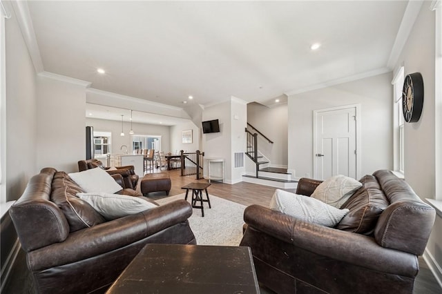 living room with wood finished floors, recessed lighting, stairs, and crown molding