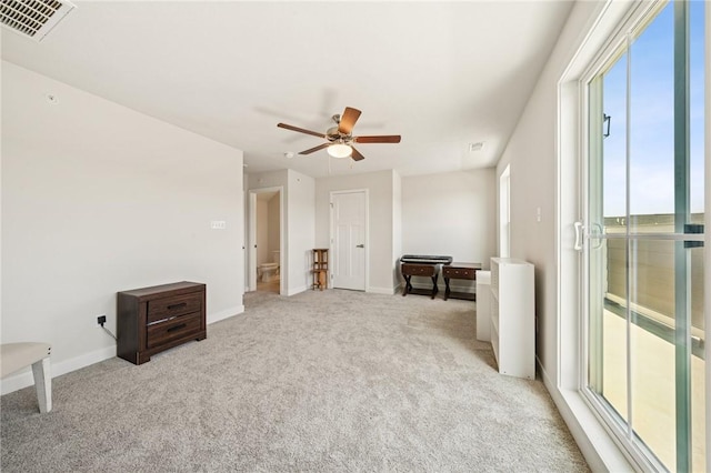 interior space featuring a wealth of natural light, a ceiling fan, baseboards, and visible vents
