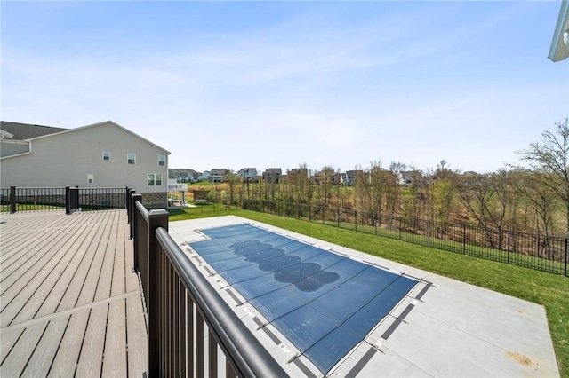 view of pool featuring a wooden deck, a residential view, a lawn, and fence