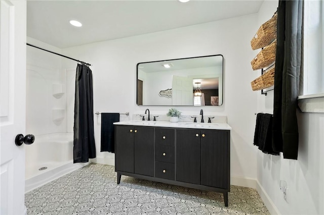 full bathroom featuring recessed lighting, a sink, double vanity, and a stall shower