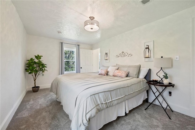 bedroom with baseboards, visible vents, and carpet