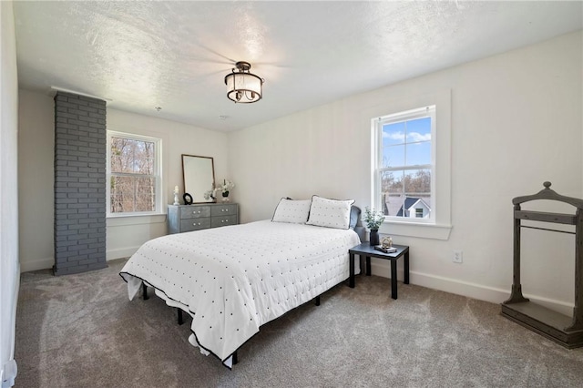 bedroom featuring baseboards, carpet flooring, and a textured ceiling