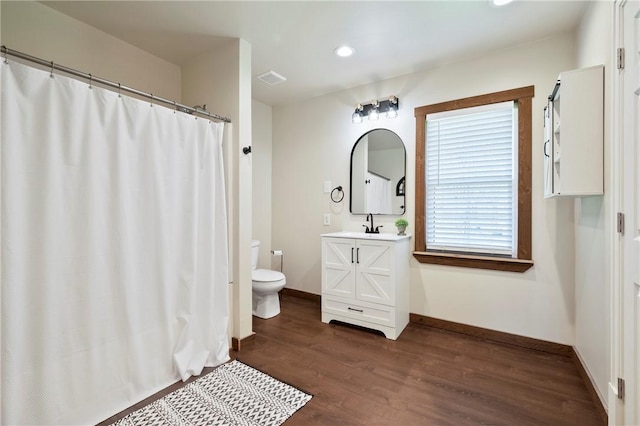 bathroom featuring recessed lighting, wood finished floors, toilet, vanity, and baseboards
