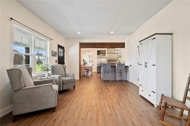 sitting room featuring light wood-type flooring, baseboards, an inviting chandelier, and recessed lighting