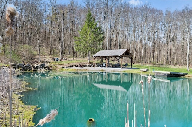 view of pool with a gazebo and a water view